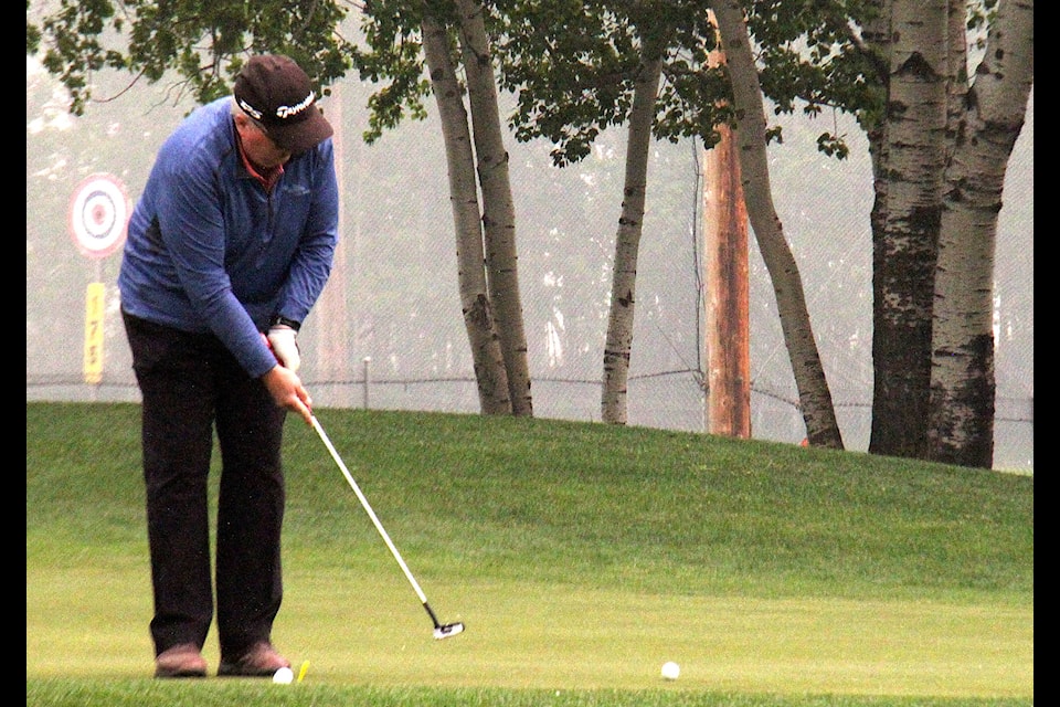 A golfer carefully putts on the green during the second annual Jumpstart Gold Tournament at Lakewood Golf Course.