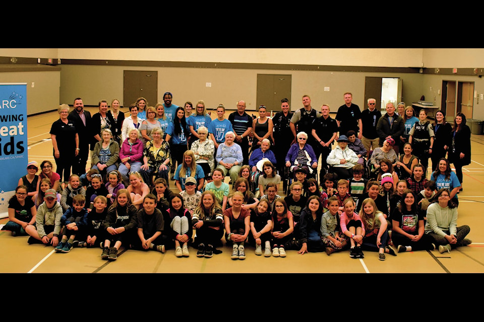 Walk the Talk participants pose for a group picture before being paired into their walking groups June 4. The seniors from Bethany were matched with students to walk the Community Centre gym and chat. Photo by Kaylyn Whibbs/Sylvan Lake News