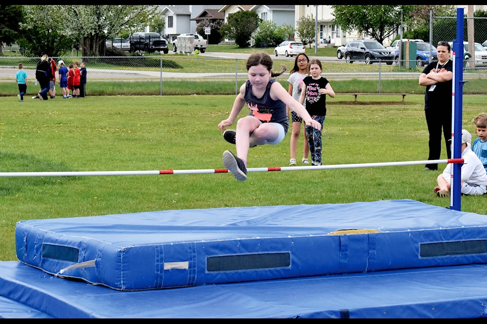 Whitlie Kennedy leaps over the bar in high jump at C.P. Blakely Elementary School’s Grades 3-6 Track Day on June 6. The students competed in various sporting events throughout the day. Photo by Kaylyn Whibbs/Sylvan Lake News
