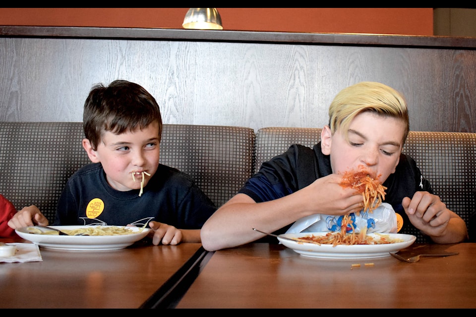 Kasey Gardner (left) and Reece Rowsell-Dixon show off different strategies as they try to be the first to finish their plate in the Kids Under 12 category at the Spaghetti Eating Contest on June 9. The annual event, hosted by the Flipside Youth Centre, Community Partners Association and Sylvan Lake Boston Pizza, served as a fundraiser for local youth programs. Photo by Kaylyn Whibbs/Sylvan Lake News