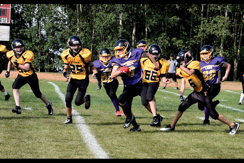 Sylvan Lake Lions’ Joshua Lewis carries the ball into a sea of Drumheller Titans during the Saturday afternoon matchup on Sept. 7. The Lions clawed to a 28-14 win over the Titans. Photo by Kaylyn Whibbs/Sylvan Lake News