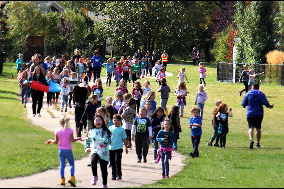 Students from Ecole Our Lady of the Rosary run down a pathway to a crosswalk back to the school yard to finish off their Terry Fox Run on Sept. 24. Photo by Megan Roth/Sylvan Lake News