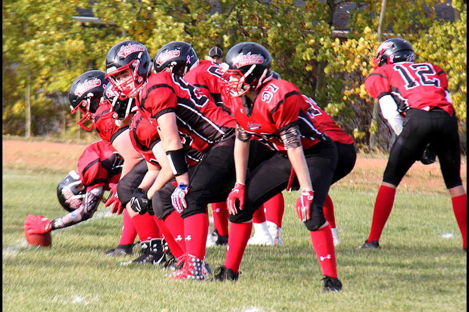 The Lakers offensive line gets into position to block for their kicker during a point-after conversion. The Lakers overwhelmed the Trojans both offensively and defensively with a final score of 59-3.