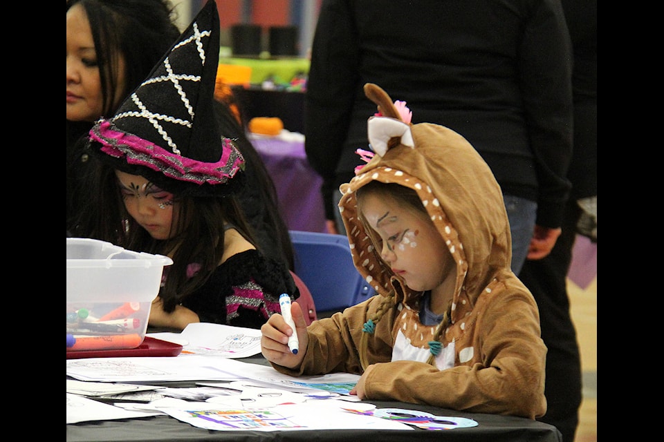 A deer and a witch sit side by side while colouring Halloween-themed pages during the annual Spooktacular Extravaganza at the multi-campus on Oct. 26. Photos by Megan Roth/Sylvan Lake News