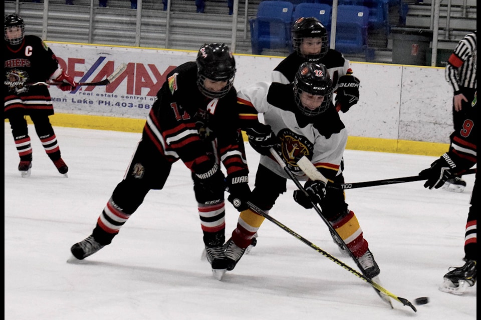No. 12 Kennedy Sisson battles with a member of the Red Deer Chiefs during the Sylvan Lake Peewee A Lakers’ game on Dec. 14. Sisson is credited for two assists for the Saturday afternoon game. Photo by Kaylyn Whibbs/Sylvan Lake News