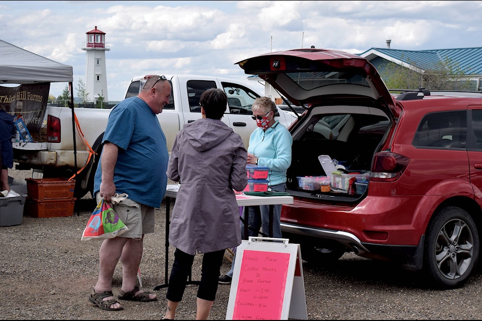 A pair check out a vendor at the opening day of the Sylvan Lake Farmers’ Market on June 5. The market opened for the summer following COVID-19 guidelines. Photo by Kaylyn Whibbs/Sylvan Lake News