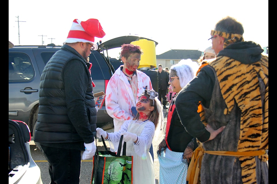 Alliance Community Church Pastor Tim Bergmann, dressed as Cat in the Hat, hands out candy during the church’s Trunk or Treat event on Halloween. Bergmann asked those who came seeking candy a simple question: Can you name a Dr. Seuss character? (Photo by Megan Roth/Sylvan Lake News)