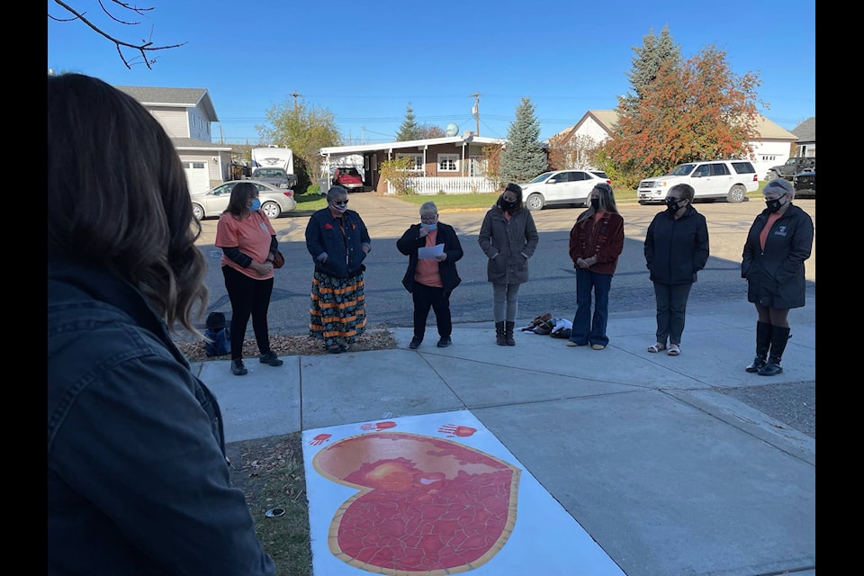 Mayor Helen Posti addressing individuals gathered outside Eckville Junior Senior High School for unveiling of the Indigenous artwork. (Janeil Humphrey / Submitted photo)