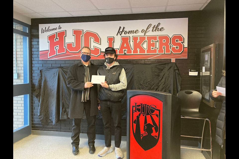 Mike Garrow (left) presented Reuben Braitenback (right) with the Sylvan Lake Lion’s Legacy Scholarship for his school and community involvement, academics and citizenship.