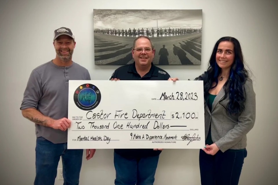 Cheryl Rayfield presented a cheque to members of the Castor Fire Department. 