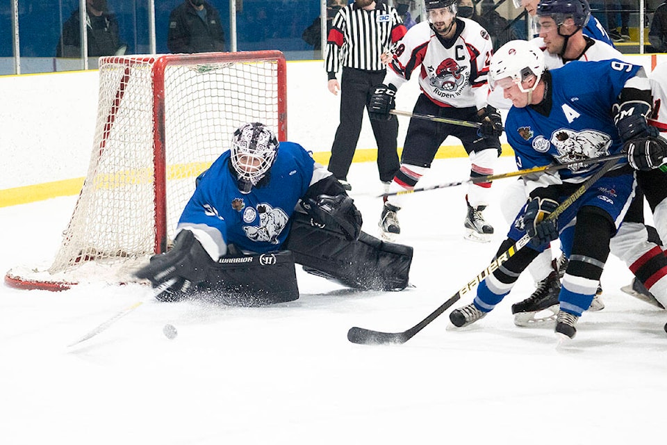 Austin Turner of the Terrace River Kings holds off a Rupert Rampage attack on net on Feb. 4. (Photo: Norman Galimski/The Northern View)