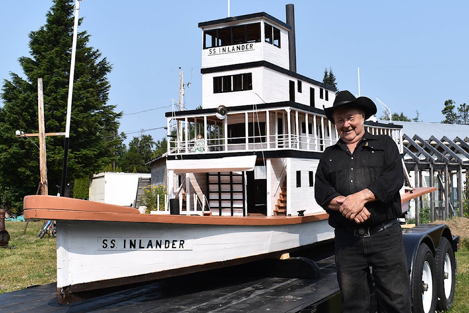 Carpenter Lyle Krumm stands next to his 22-foot long model of the Inlander in his front yard in Thornhill. (Brittany Gervais photo)