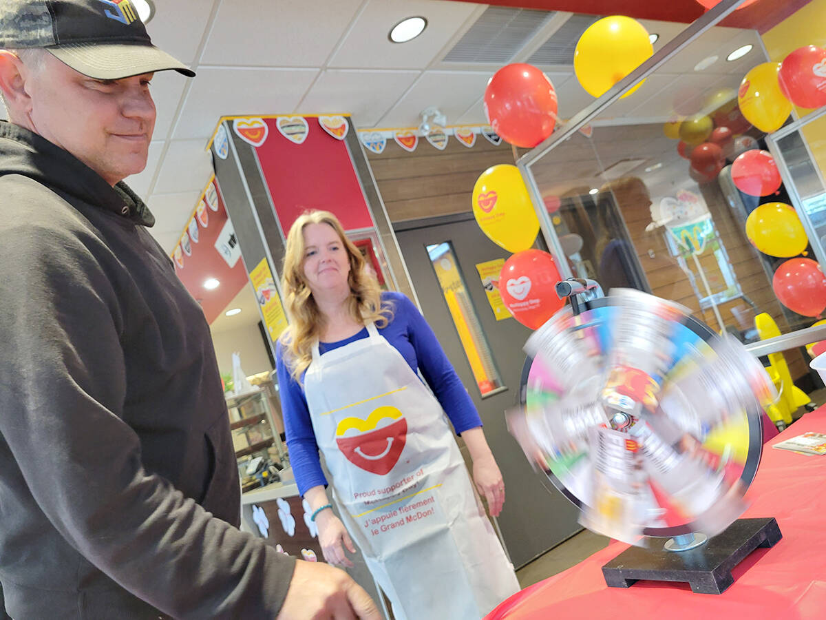 Volunteer Lanette Salisbury encouraged visitors to try the prize wheel at the Langley Murrayville McDonalds on Wednesday, May 11, McHappy Day. Money was being raised for the Langley Foundry and Ronald McDonald House B.C. (Dan Ferguson/Langley Advance Times)