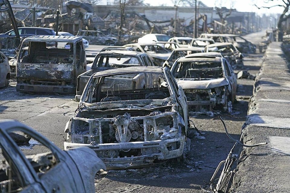 Burnt out cars line the sea walk after the wildfire on Friday, Aug. 11, 2023, in Lahaina, Hawaii. Hawaii emergency management records show no indication that warning sirens sounded before people ran for their lives from wildfires on Maui that killed multiple people and wiped out a historic town. Instead, officials sent alerts to mobile phones, televisions and radio stations — but widespread power and cellular outages may have limited their reach. (AP Photo/Rick Bowmer)