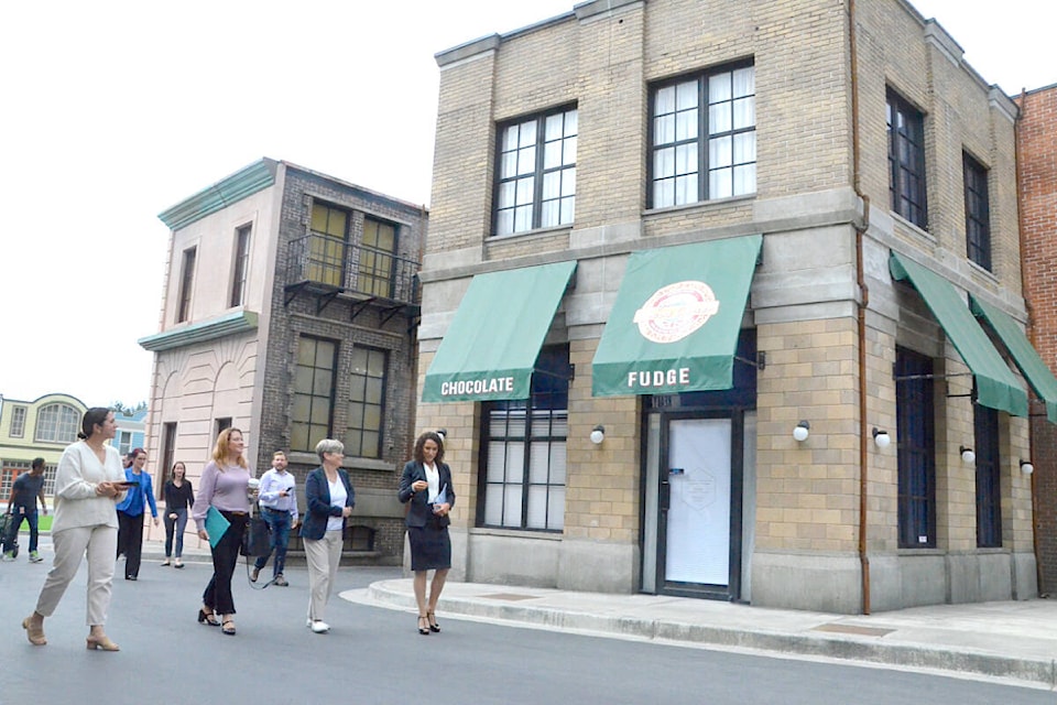 Martini Studios CEO Gemma Martini (right) showed guests around Martini Town after her studio received a clean energy award on Sept. 6. (91ԭ Advance Times files)