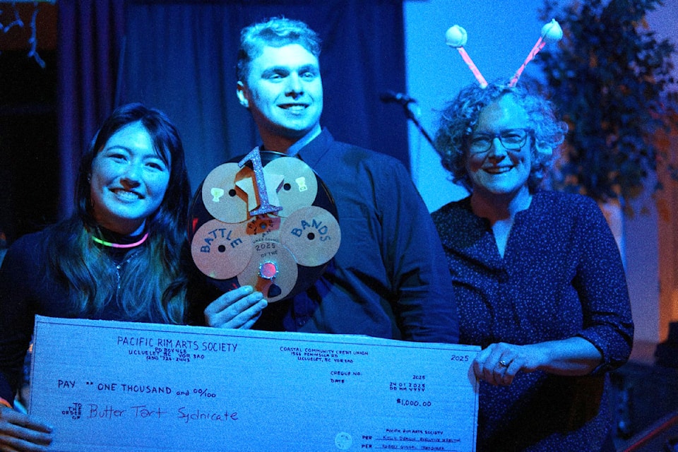 Members of the Butter Tart Syndicate receive $1,000 as part of their prize for winning Pacific Rim Arts Society's Battle of the Bands at the end of January 2025. 