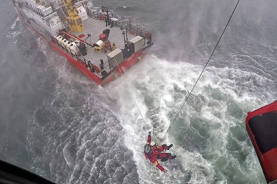12464245_web1_180625-CVR-M-SAR-Techs-lowered-to-deck-of-CCGS-M-Charles-in-Nootka-Sound---24-June-2018