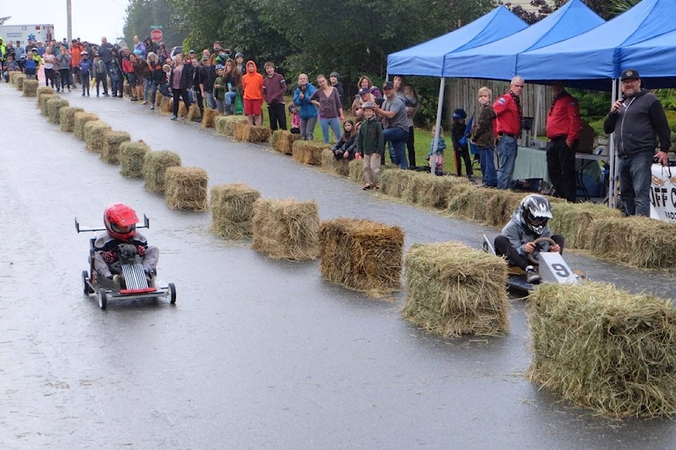 Racers Bodey Hasz, right lane, and Khan Furey rocket down Bay Street in the final heat of the revived Ucluelet Soapbox Derby. Hasz, 11, went on to win Saturday’s fun, four-wheeled event with his understated kit-car called ‘Number Nine’. Furey, 7, placed second out of 48 other young racers and Bo Smith was third. (Nora O’Malley / Photos)