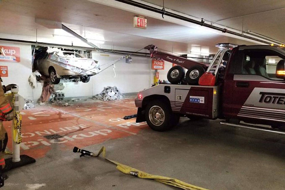 A vehicle that was driven through the wall of a parkade at Uptown Shopping Centre and into the nearby Walmart on April 9 was removed through another hole in the wall later that night. (Photo via Saanich Police Department and Ayush Kakkar)