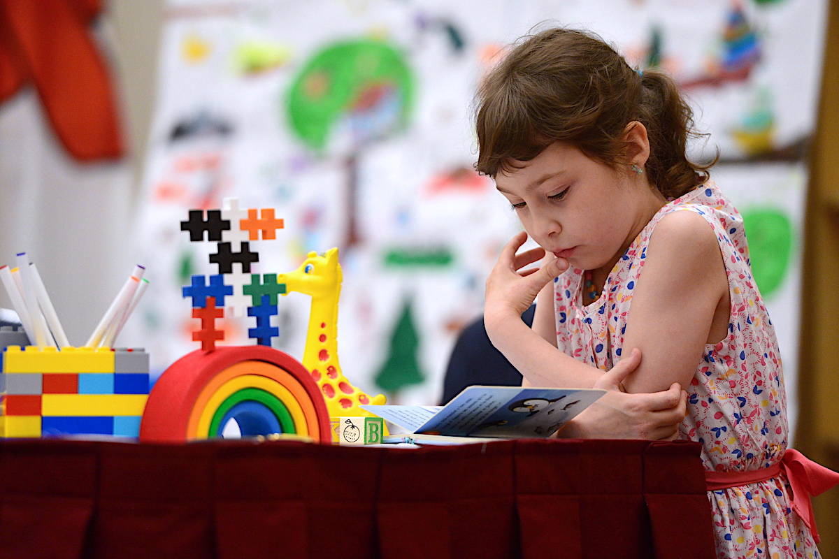 Eleonore Alamillo-Laberge, 6, reads a book in Ottawa on Monday, June 12, 2017. THE CANADIAN PRESS/Sean Kilpatrick