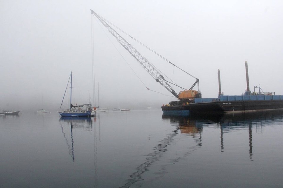 The Dead Boat Disposal Society, Songhees Nation and Ralmax (Salish Sea Industrial Services) remove eight boats from the waters off Oak Bay. (Christine van Reeuwyk/News Staff)