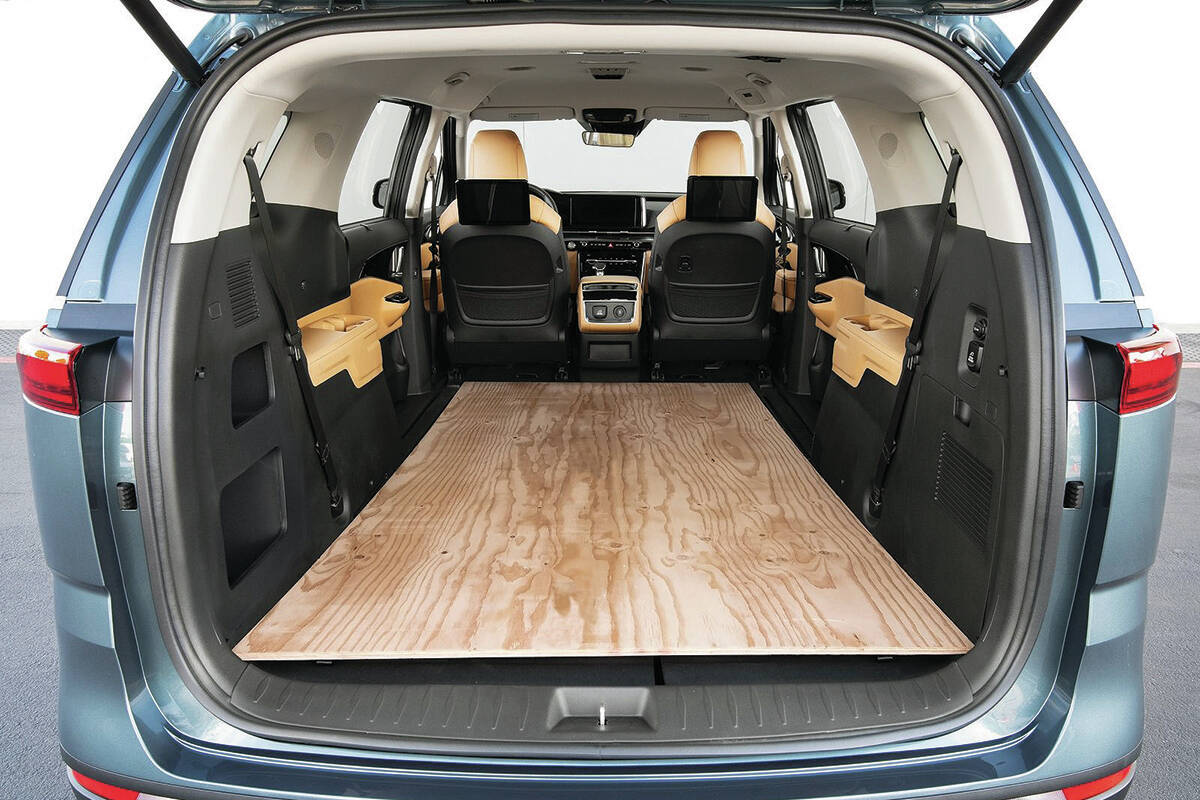 One common benchmark between competing minivans is that 4x8 sheets of building material must fit inside with the rear door closed. PHOTO: KIA