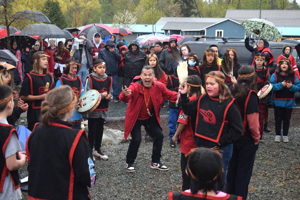Trevor Little leads students from Haahuupayak Elementary School in a song at Millstone Park in Port Alberni for the Missing and Murdered Indigenous Women and Girls National Day of Action on May 5, 2022. (ELENA RARDON / ALBERNI VALLEY NEWS)