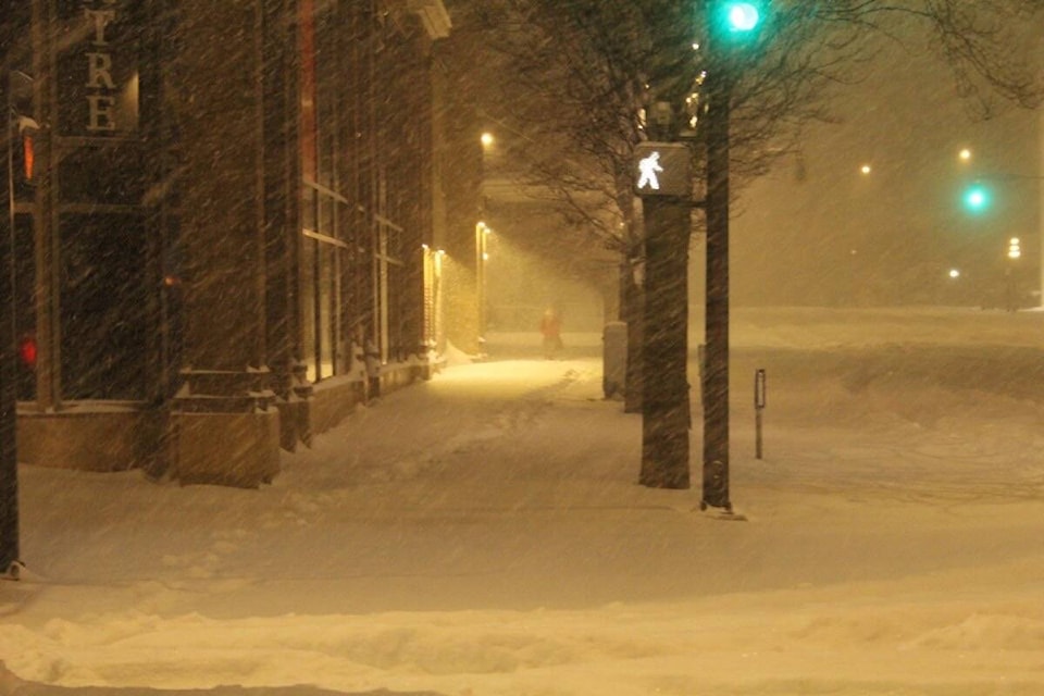 Blanshard and Douglas streets in Victoria remain snow-covered – as the white stuff continues to fall – with pedestrians resorting to the street as sidewalks predominantly remain uncleared as of 7 a.m. Dec. 20. (Christine van Reeuwyk/News Staff)