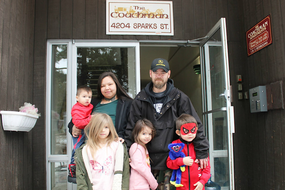 Bonnie Forsythe with her family at the Coachman Apartments complex in Terrace. (Michael Bramadat-Willcock/Terrace Standard)