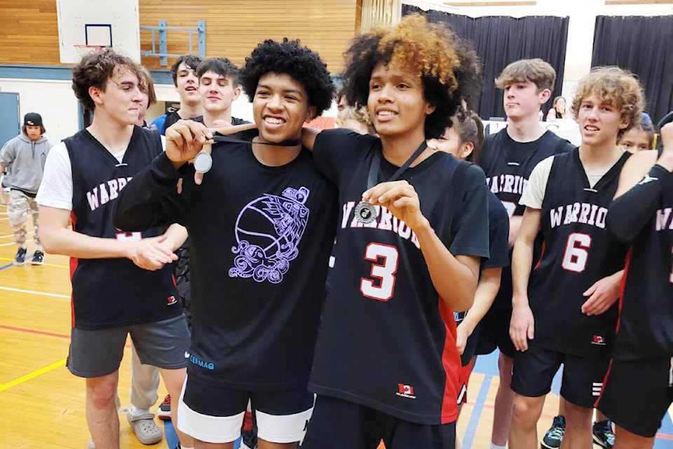 Tournament MVP James Ortiz-Castro, right, and best defensive player Anthony Robinson, left, from USS Warriors, celebrate victory at a tournament in Gold River. (Ornella Cirella photo)