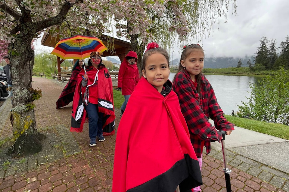 Colleen Peters (with umbrella) and her granddaughters, Alannah and Tatianna Peters, walk along Victoria Quay in the MMIWG2+ Walk of Remembrance, May 5, 2023 in Port Alberni. (SUSAN QUINN/ Alberni Valley News)