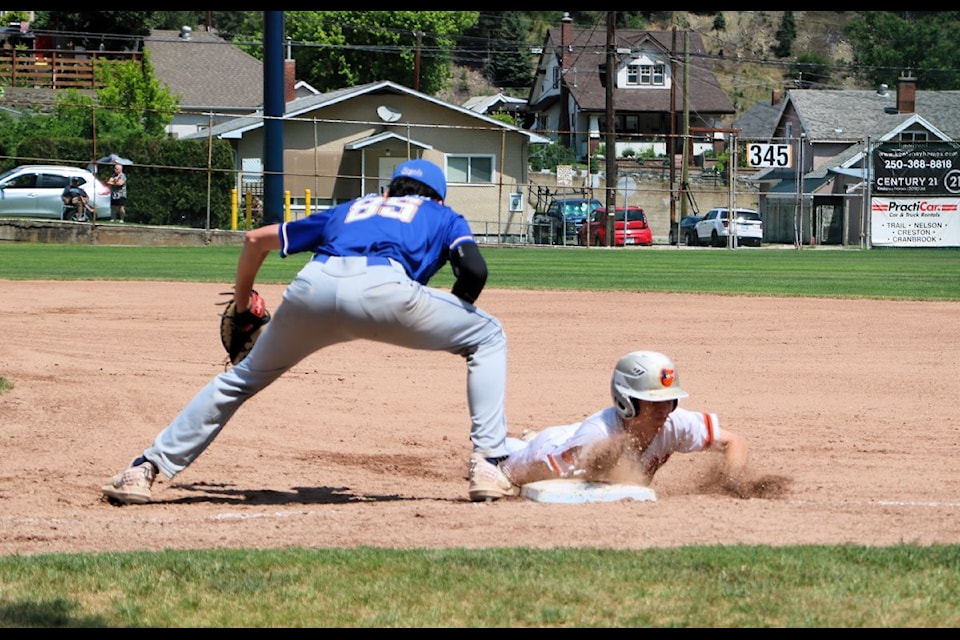 Ridge Meadows Royals attempt to pick off the Trail Orioles runner at first.