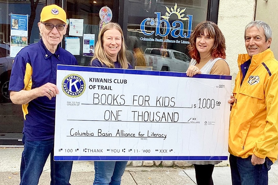 Trail Kiwanis has donated $1,000 to Books for Kids. L-R: Wayne Hodgson, Kiwanis treasurer; Jodie Campbell, CBAL's Community Literacy Outreach Coordinator; Jamie Santano, Rossland StrongStart; and Chris Vlanich, Kiwanis president.