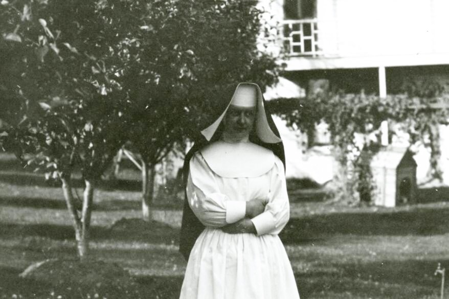 Sister Loretto, pictured here around 1912, with Mater Misericordiae in the background.