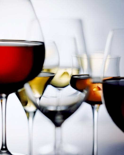 Red and white wine glass on white background, close-up