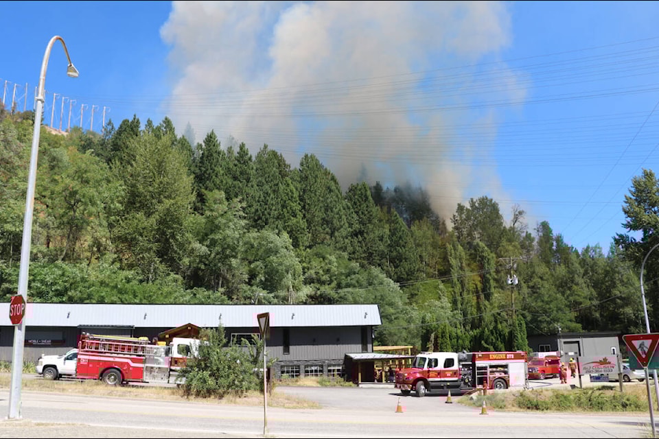 Kootenay Boundary Regional Fire and Rescue was on scene as a fire burned close to local businesses on the Warfield hill on Hwy. 3B near Trail. Photos: Jim Bailey