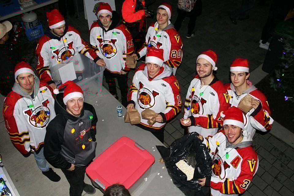 Members of the Victoria Cougars were in charge of handing out free popcorn, courtesy of the Esquimalt Lions Club, at Sunday’s Esquimalt Celebration of Lights at Archie Browning Sports Centre. Don Descoteau/Victoria News