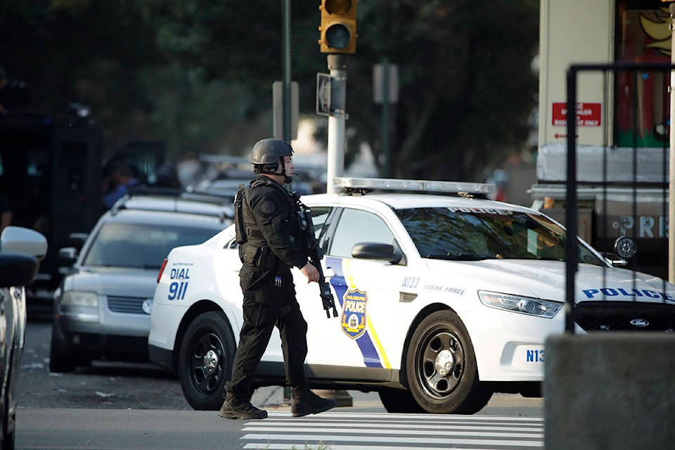 A police officer patrols the block near a house as they investigate an active shooting situation, Wednesday, Aug. 14, 2019, in the Nicetown neighborhood of Philadelphia. (AP Photo/Matt Rourke)