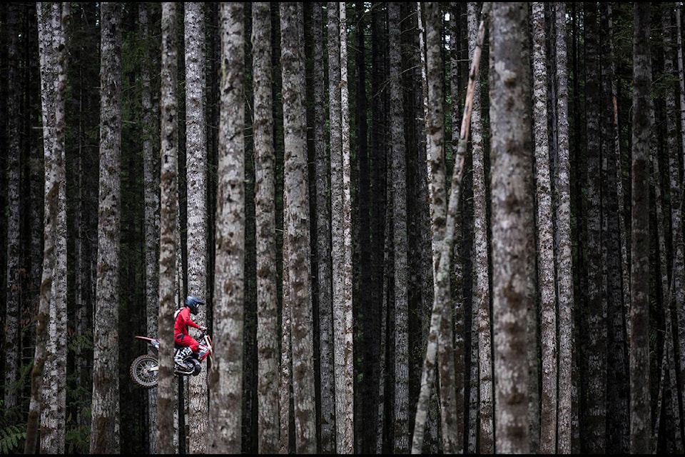 Alex Haley takes off from a jump in the forest during a motocross race in Campbell River. Photo by Marissa Tiel/Campbell River Mirror