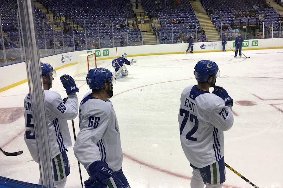 Aaron Thow (left), Vincent Arseneau (middle) and Mitch Eliot (right) waited their turn during practice. (Devon Bidal/News Staff)