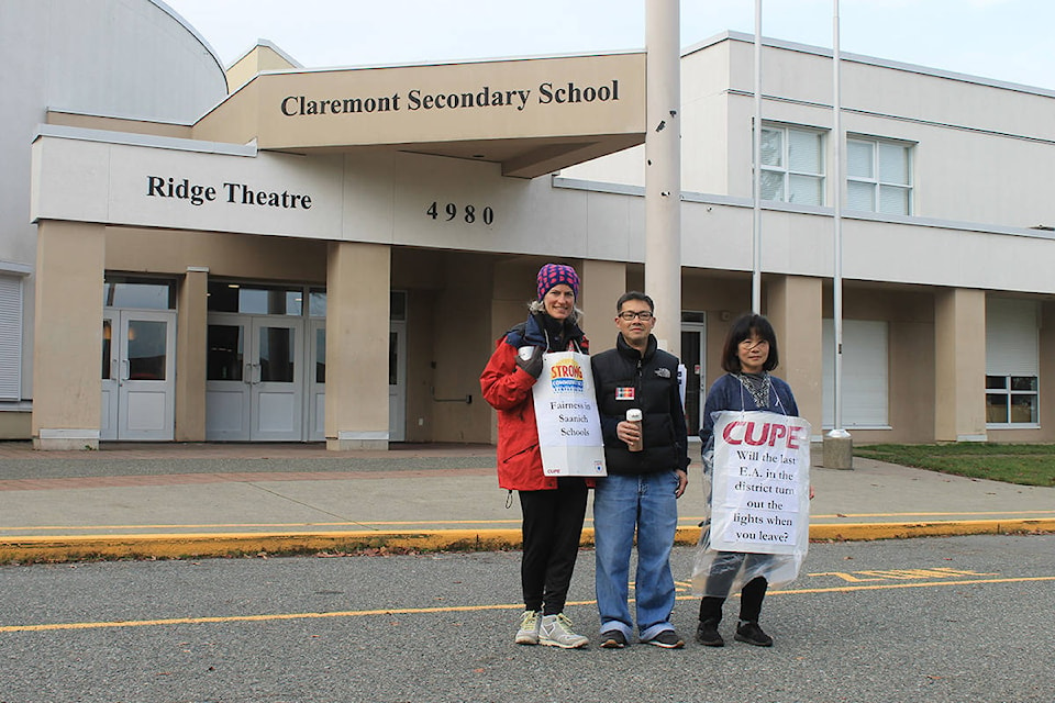 Career Centre Coordinator Cammie Watson (left), Custodian Danny Tang (centre), and Educational Assistant Helen Casey (right) participate in ongoing job action in SD63 on Thursday, Nov. 14. (Sophie Heizer/News Staff)