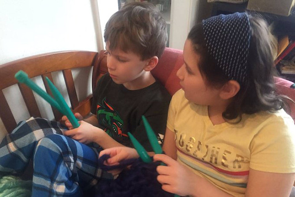 Haley Paetkau (right) taught her little brother Jacob to knit so they could tackle the project together. (Photo courtesy Steve Sxwithul’txw)