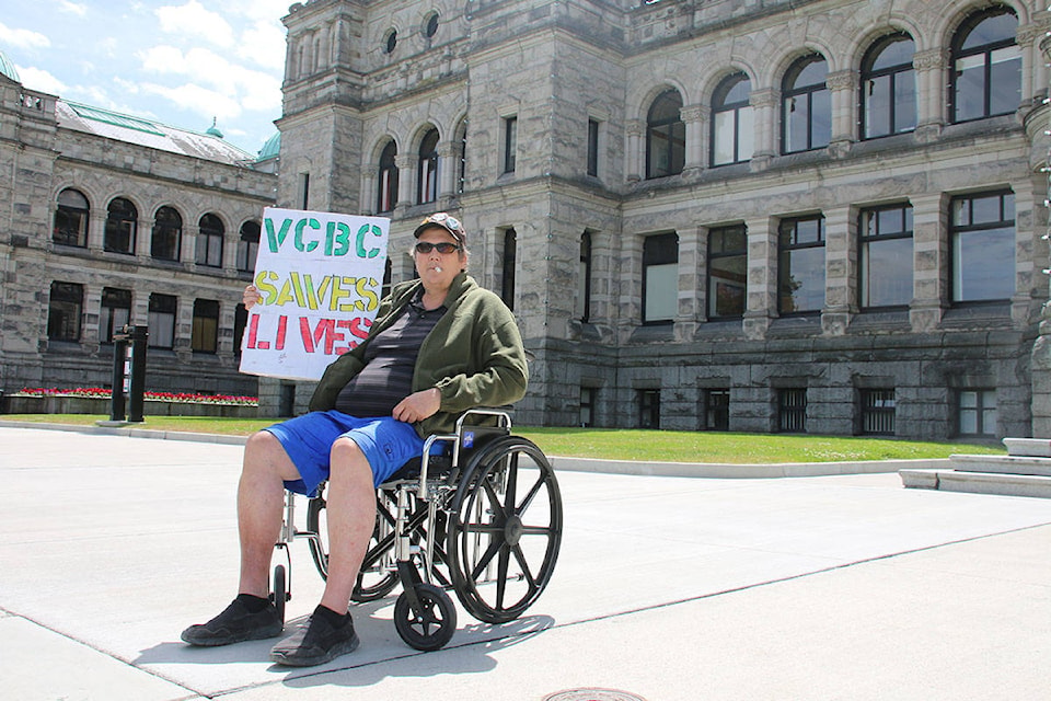 Simon Kitka shows his support for the Victoria Cannabis Buyers Club at a rally on Thursday at the Legislature. (Kendra Crighton/News Staff)