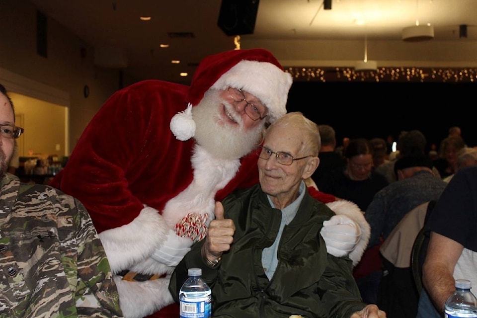 More than 250 people attended the 2018 Earl Naswell Community Christmas Dinner, including the founder of the event, Earl Naswell (pictured, with Santa). Photo by Terry Farrell