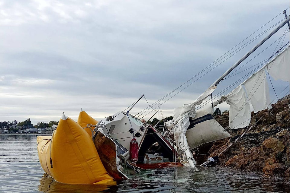 A 23-foot sailboat that broke free from its anchor was smashed against Cattle Point during the early October south-easterly storms. (Ron Geezin Photo)