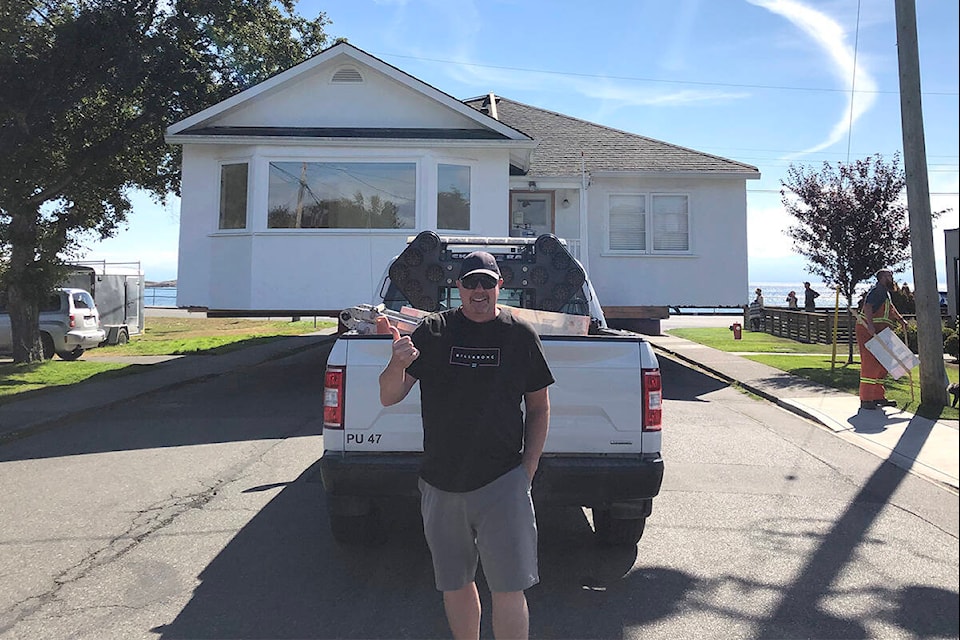 Cooper Shantz, former owner of 575 St. Patrick St., stands in front of his old home before it was barged to the San Juan Islands. (Photo courtesy of Cooper Shantz)