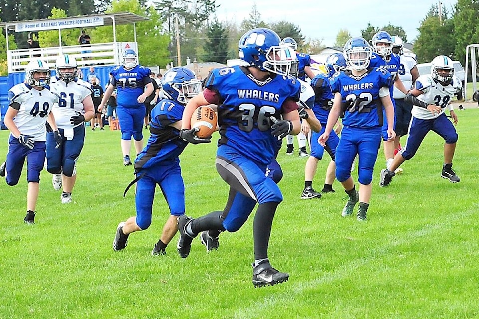 Ballenas Junior Whalers player Caden Prontack finds an opening and makes a dash to the end zone for a touchdown against the visiting Belmont Bulldogs in an exhibition game at Ballenas field on Sept. 8. (Michael Briones photo)