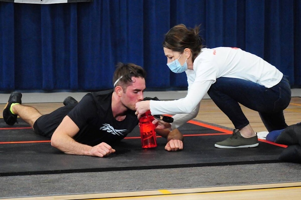 Mitchel Cook gets a water break during his attempt to set a new Guinness World Record for burpees. (Michael Briones photo)