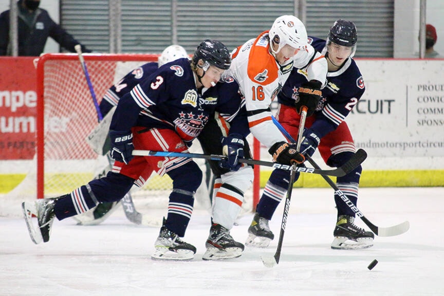 Cowichan defencemen Connor Elliott (3) and Mason Croucher (22) put the squeeze on Nanaimo forward Brody Waters during the teams’ game at the Cowichan Arena last Wednesday. (Kevin Rothbauer/Citizen)