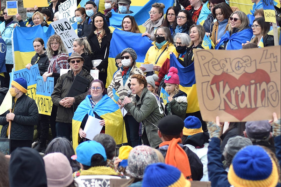 Tamara Krawchenko, a Ukrainian resident of Victoria, addresses a crowd of hundreds at the B.C. legislature in support of Ukraine on Feb. 27. (Kiernan Green/News Staff)